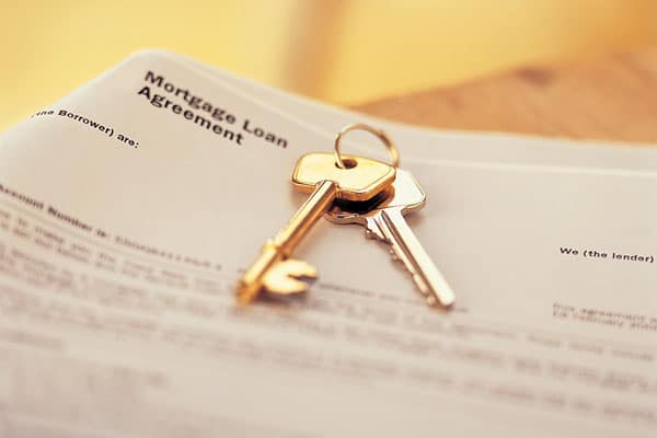 Keys laying on top of a mortgage loan agreement
