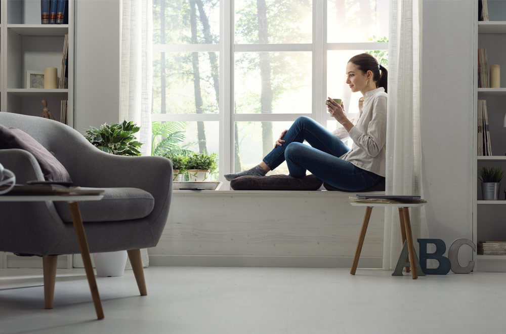 Woman relaxing in her home thinking about mortgage refinance