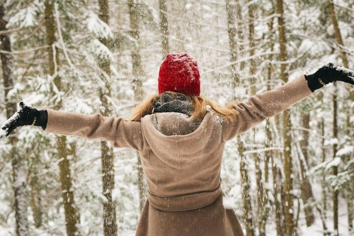 woman in winter forest beating the winter blues by paying off your mortgage faster