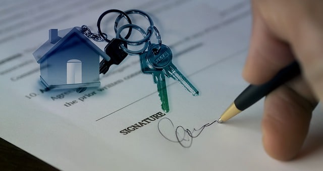 person signing closing paperwork on their new property