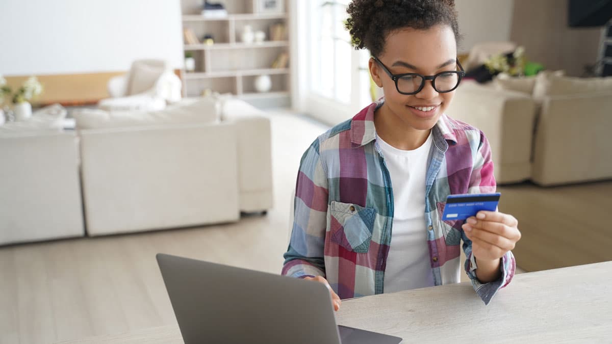 Teenager using credit card to buy stuff online