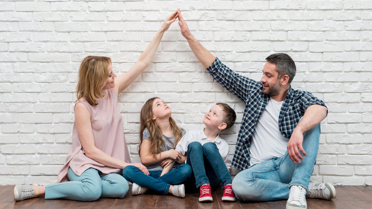 Family discussing their mortgage sitting on ground